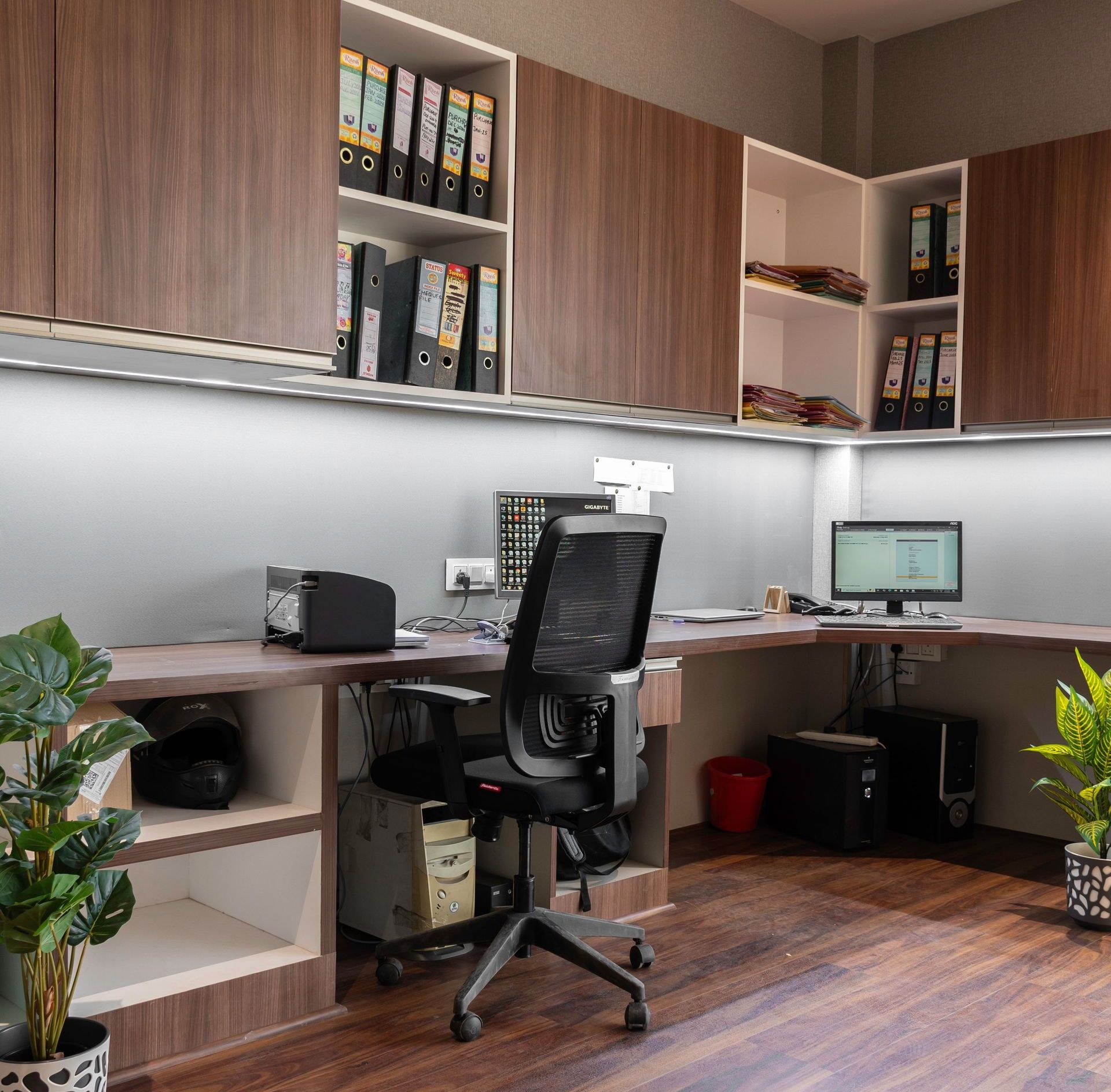 Stylish office setup featuring wooden cabinetry and modern furnishings. Ideal workspace inspiration.